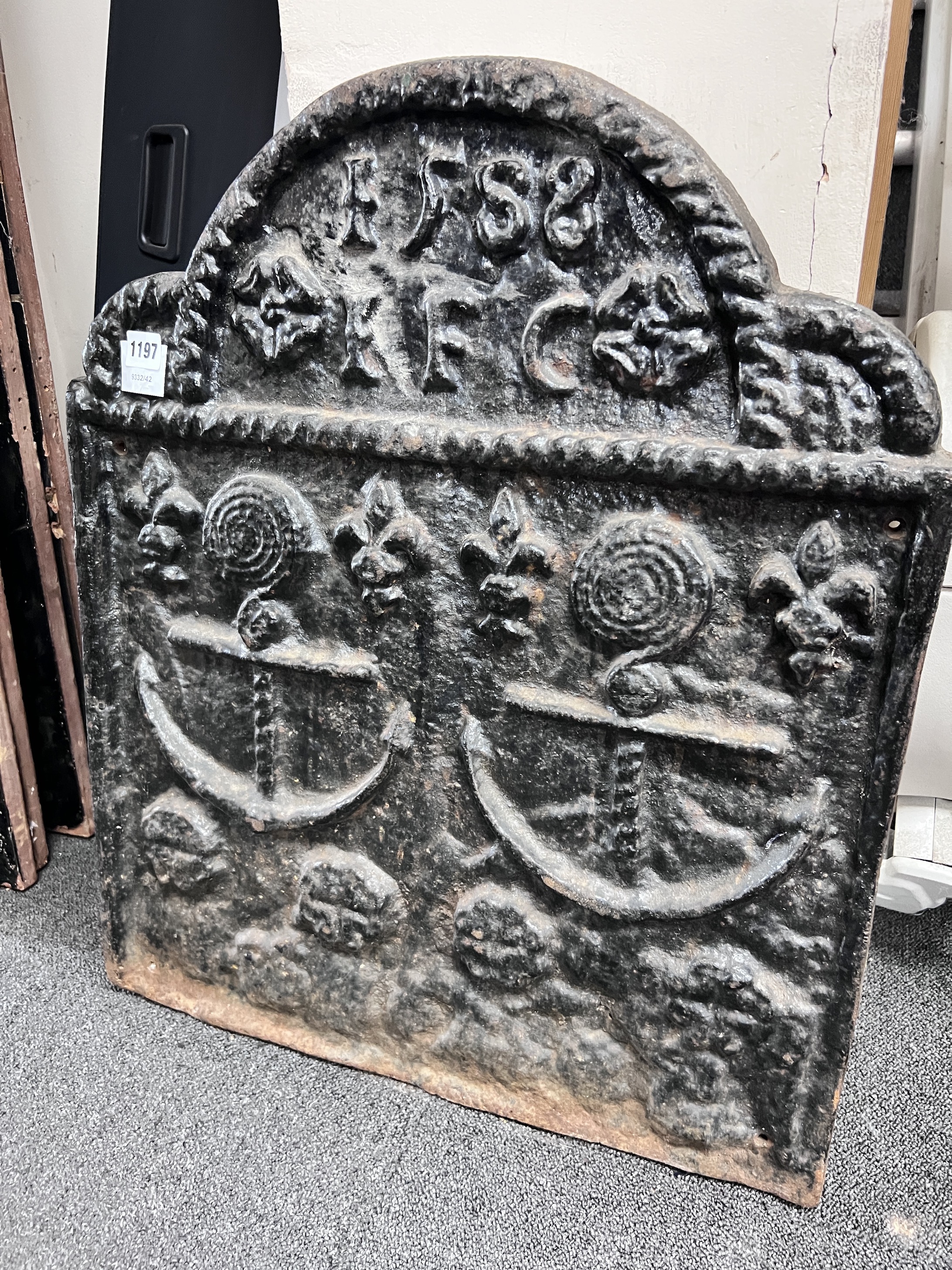 A cast iron fireback, bearing date 1588 and decorated with twin anchors, width 55cm, height 66cm